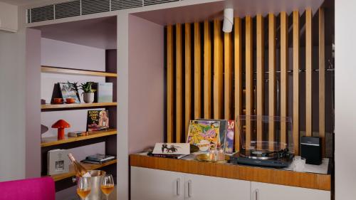 a room with a counter with a window with yellow blinds at Hotel Indigo Sydney Potts Point by IHG in Sydney