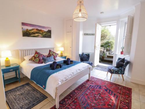 a bedroom with a bed and a large window at The Hideaway in Great Malvern