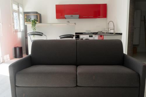 a couch in a living room with red cabinets at Savanna Sky in Fort-de-France