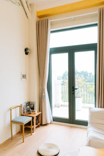 a living room with a large sliding glass door at X-Stay in Hai Phong