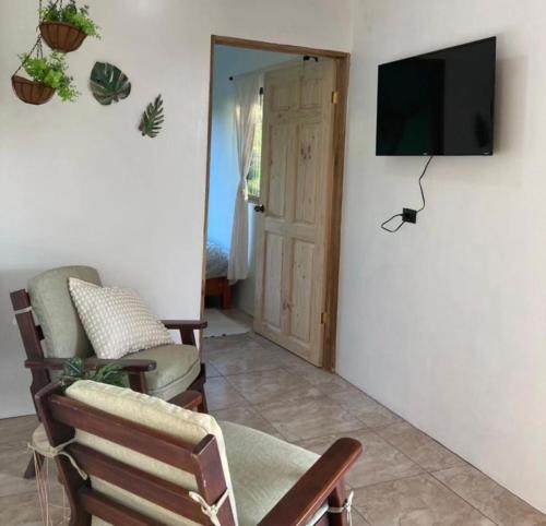 a living room with a tv on a wall at Rincón Sereno San Carlos in La Marina