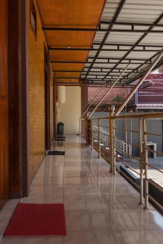 an empty hallway of a building with a red rug at Gokhon Guest House in Tuk Tuk