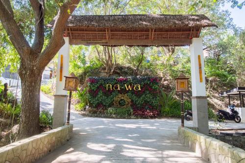 a entrance to the nova sign at the entrance to a garden at NAWA Wellness in Calatagan