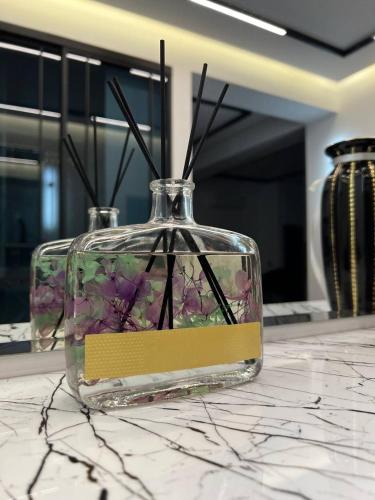 a glass jar with flowers in it on a counter at Hi-Tech Apartment in Tashkent