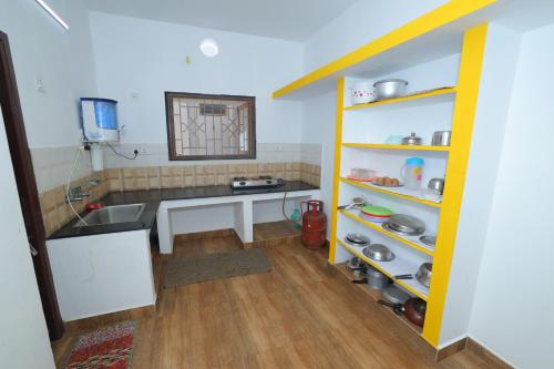 uma cozinha com um lavatório e uma bancada em SJ Villa em Pondicherry