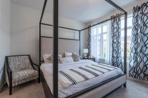 a bedroom with a canopy bed and a window at Room 1 of Lovely Montgomery Home, downtown Calgary in Calgary