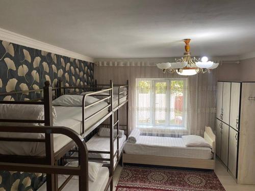 a room with two bunk beds and a window at Sunny Guest House in Osh