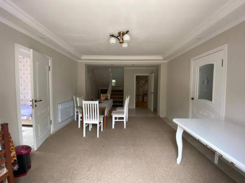 a dining room with a table and chairs at Sunny Guest House in Osh