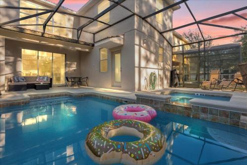 a swimming pool with a house with a donut in it at Perfect Disney Holiday! Private Pool, Spa, Resort! in Kissimmee