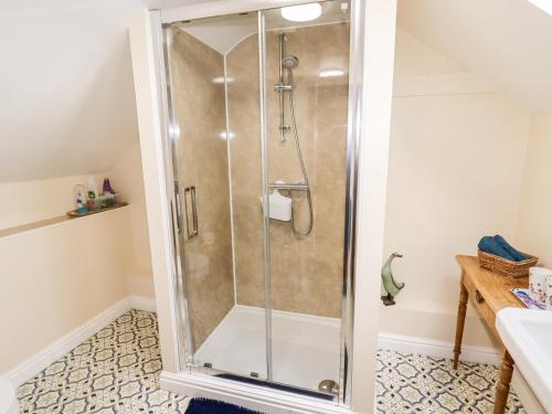 a shower with a glass door in a bathroom at The Laurels Barn in Oswestry
