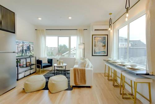 a living room with a kitchen and a living room with a table at Seattle Charm, near university,3 BR,W&D, fast wifi in Seattle