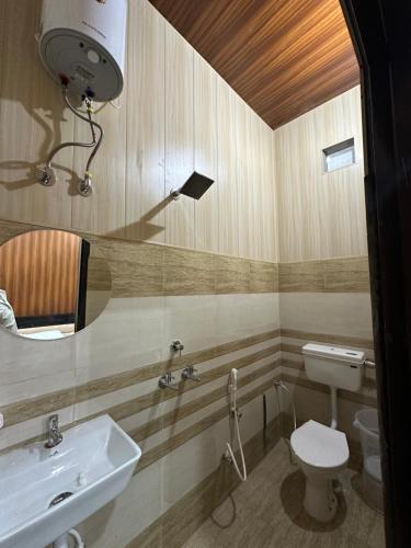 a bathroom with a sink and a toilet at CLASSIO RESIDENCY in Abohar