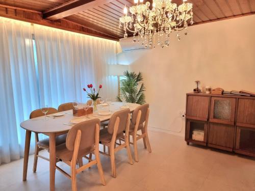 a dining room with a table and chairs and a chandelier at Classic LeeYou in Seoul