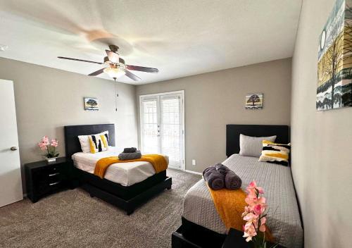 a bedroom with two beds and a ceiling fan at Life Can Be A Beach in Galveston