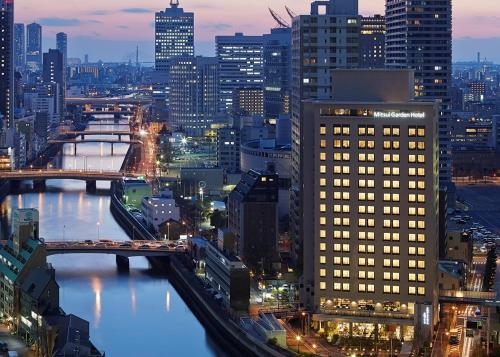 a view of a city skyline at night at Mitsui Garden Hotel Osaka Premier in Osaka