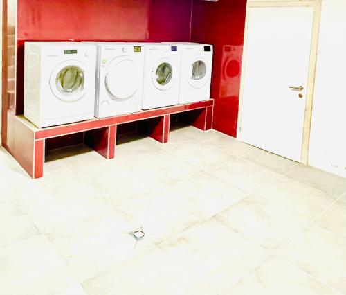 a laundry room with two washing machines on a tiled floor at YS Apartments e.U. in Marchtrenk