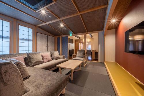 a living room with a couch and a table at RESI STAY Fuyacho in Kyoto