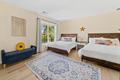 a bedroom with two beds and a blue couch at 13-Acre Private Estate, Private Lake, Private Golf Range, Private Forest & Hiking Trails in Ross Corner