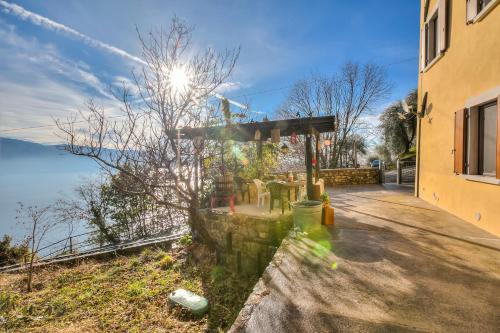 a building with a view of the water at Faby House On Hilly Area & Lake View - Happy Rentals in Gargnano