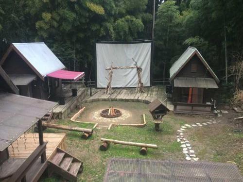 a park with a play area with a tent and a playground at Nakadaki Art Village in Isumi