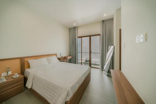 Postel nebo postele na pokoji v ubytování De V’Charm Hotel