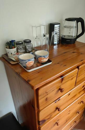 a wooden dresser with two bowls on top of it at House of Art in Haenertsburg