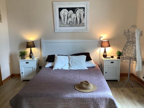 a bedroom with a bed with a hat on it at Villa climatisée avec piscine in Pont-Saint-Esprit