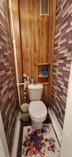 a small bathroom with a toilet and a rug at Двухкомнатная квартира на юго-востоке г.Караганда in Karagandy