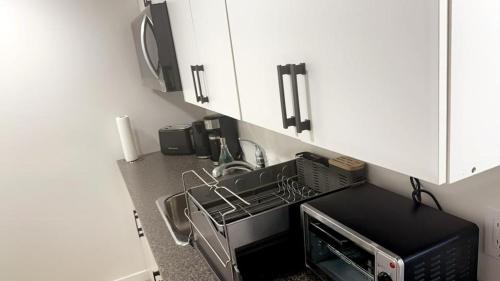 a kitchen with a microwave and a toaster oven at Guest expertise in Winnipeg