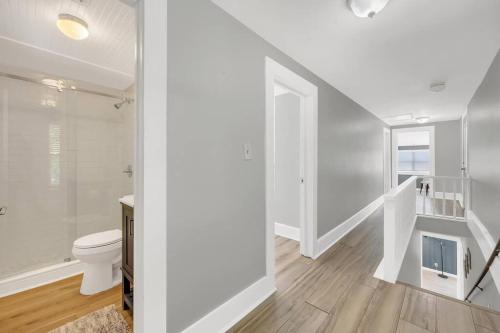 a white bathroom with a toilet and a staircase at Night Lights at De Haven in St. Augustine