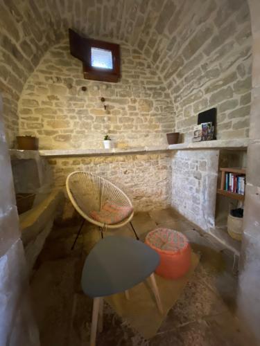 a room with two chairs and a table and a window at Gîte de Lespinasse in Saint-Cernin