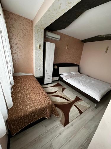 a bedroom with two beds in a room with at KK Apartments in Stara Zagora