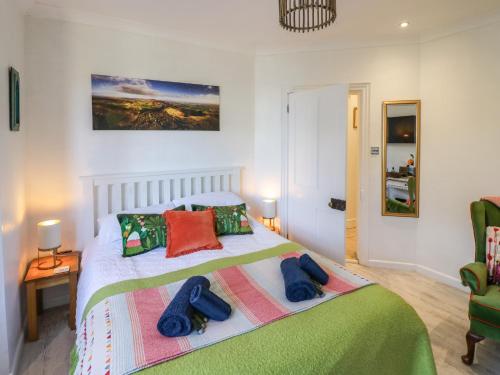 a bedroom with a bed with two towels on it at The Escape in Great Malvern