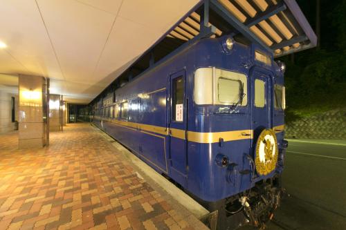 a blue train is parked in a train station at Okuhida Garden Hotel Yakedake in Takayama
