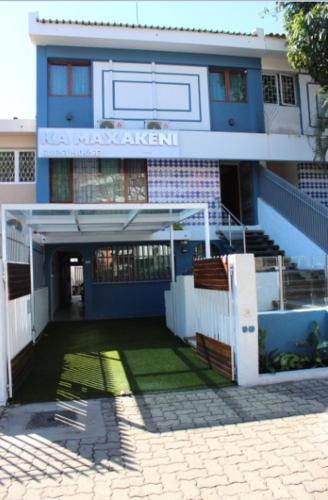 a blue building with a sign on top of it at Ka maxakeni guesthouse in Maputo