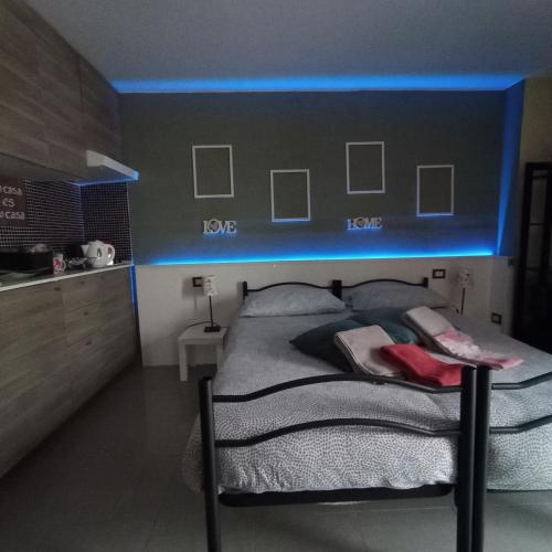 a bedroom with a bed with a blue light above it at villa verde bed and breakfast in Uggiate-Trevano