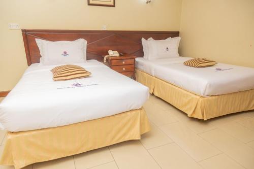Ένα ή περισσότερα κρεβάτια σε δωμάτιο στο Holiday Express Hotel Kampala