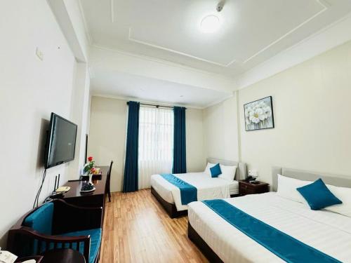 Postel nebo postele na pokoji v ubytování Khách Sạn Hùng Vương Quảng Ngãi