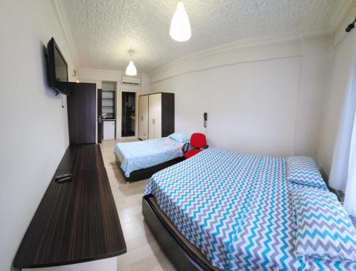Ένα ή περισσότερα κρεβάτια σε δωμάτιο στο Balıkesir karesi grup konaklama ve pansiyon