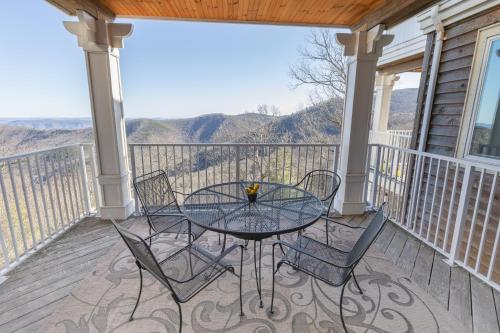 a patio with a glass table and chairs on a balcony at Art of Living Retreat Center - All Inclusive - Mountain Top Wellness Retreat in Boone