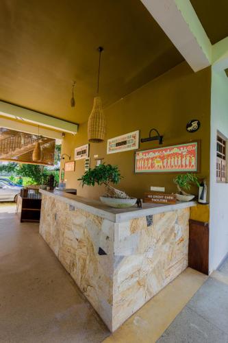 a restaurant with a counter in a room at Serene Park Hotel By Ark in Tissamaharama