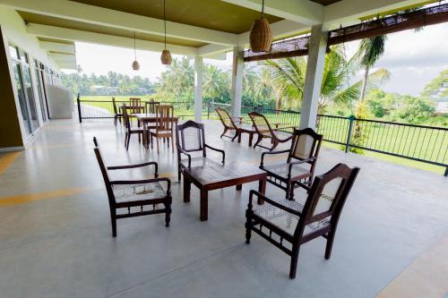 a group of chairs and tables on a patio at Serene Park Hotel By Ark in Tissamaharama