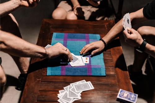a group of people playing cards on a table at Serene Park Hotel By Ark in Tissamaharama