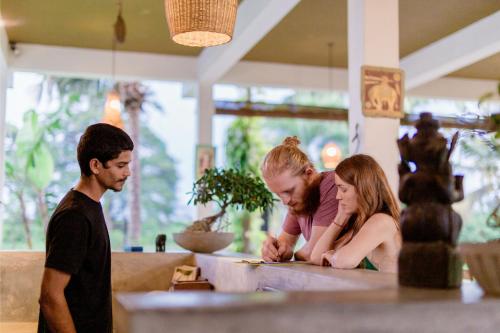 a group of people standing around a table at Serene Park Hotel By Ark in Tissamaharama