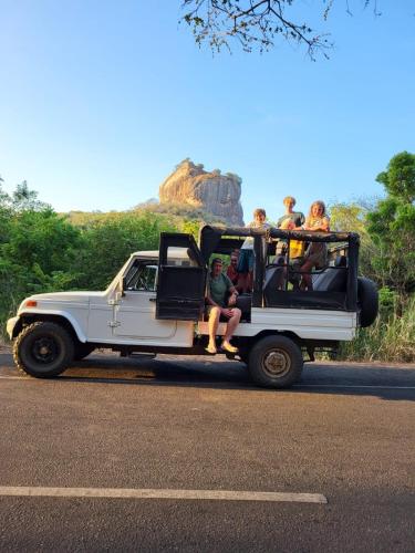 a group of people riding in the back of a jeep at Elephant safari Lodge sigiriya junction in Habarana