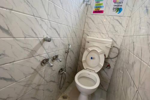 a bathroom with a toilet and a shower at Budget friendly Mini Heaven in Kolkata