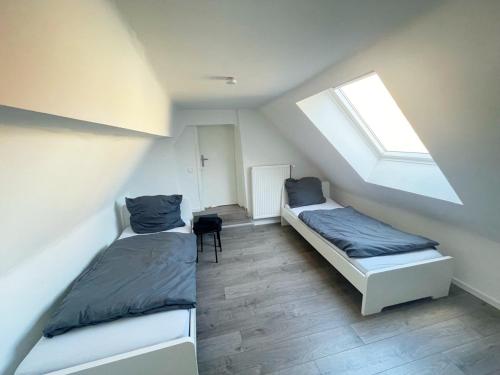 a bedroom with two beds and a window at Cozy Apartment in Bad Vilbel in Bad Vilbel