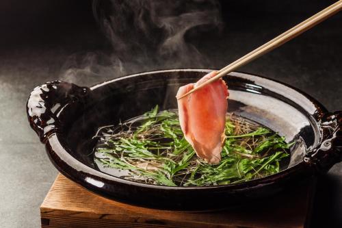 a bowl of food with a piece of meat in it at Mercure Kochi Tosa Resort & Spa in Geisei