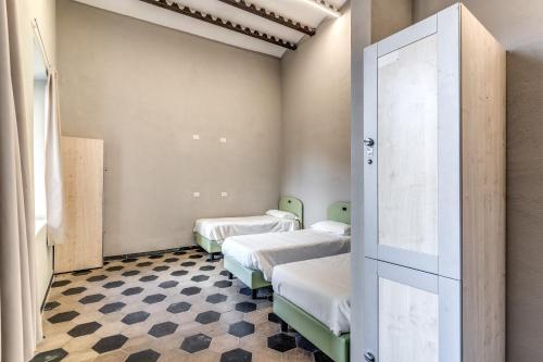 מיטה או מיטות בחדר ב-Borgo Ripa by Hostel Trastevere