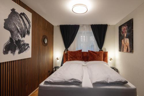 a bedroom with a bed with two pillows and a window at WELCOME APARTMENTS - Luzern in Lucerne